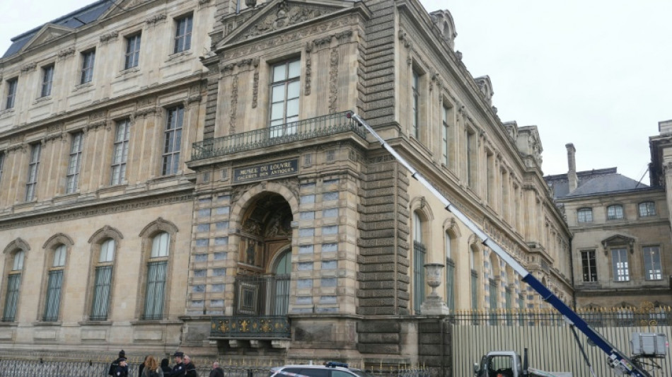 Woman charged over Louvre heist tears up in court