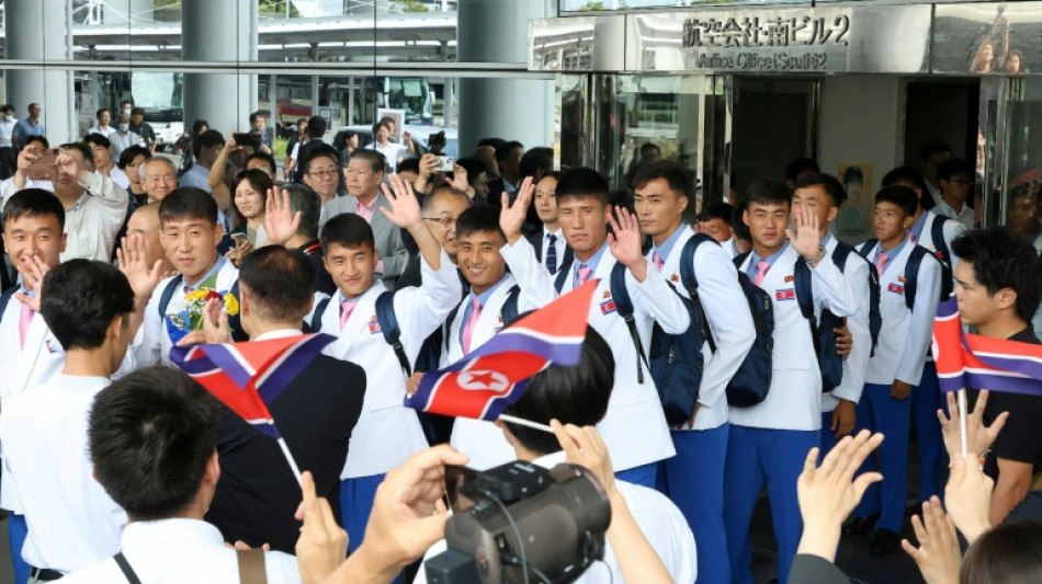 White blazers, pink ties as North Koreans land in Japan for Asian Games